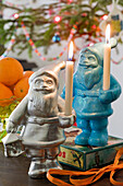 Colorful painted Father Christmas figures as candle holders