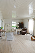 Scandinavian-style dining room with ceiling panelling and floorboards