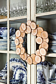 DIY wreath made out of birch wood on china cabinet