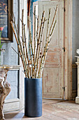 Floor vase with freshly sprouted birch branches