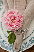 Rose and dragonfly made from wire and beads on linen napkin