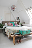 Vintage accessories in turquoise and grey in bedroom with sloping ceiling