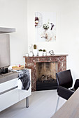 Fireplace with marble surround in white dining room