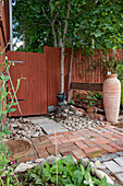 Landscaping in the garden with stones, pebbles and slabs
