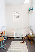 Metal bed and vintage-style accessories in child's bedroom