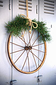 Old wagon wheel with fir branch as Christmas decoration
