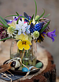 Colorful Easter bouquet of different spring flowers in a glass