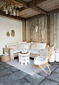 Boho lounge in the rustic loggia with wooden walls