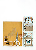 Handicraft materials with a butterfly motif on a white background