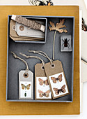 Paper gift tags with butterfly motifs in a box