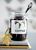Screw-top jar as a coffee canister with a butterfly motif