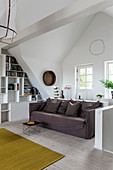 Gray sofa and bookshelves in the attic