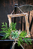 Picture frame decorated with twigs and succulents