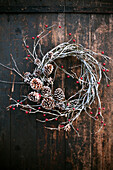 Winter wreath made from berry twigs and cones