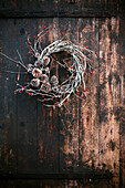 Winter wreath made of berry branches and cones