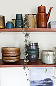 Wooden shelf with ceramic dishes