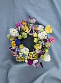 Lush colorful floral wreath with various spring flowers