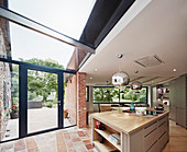 View of the dual aspect windows, doors flooding the open plan kitchen and dining space with light
