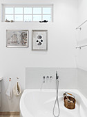 A corner bathtub in a bathroom all in white