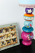 Table lamp with a decorative lamp base next to a showcase with butterflies