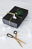 Wrapped Christmas present with handmade origami Christmas star