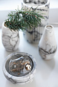 Marble vases and bowl with Christmas decorations