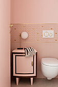 Elegant, feminine pink bathroom with gilt details