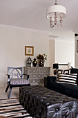 Black leather ottoman, sofa and chest of drawers with mother-of-pearl marquetry in living room