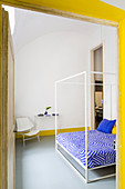 View into bedroom with yellow and blue accents