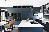Island counter and dining table in large, classic, blue-grey kitchen