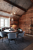 Pleasant and elegant dining room in rustic wooden cabin