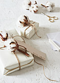Cotton bolls and tags decorating wrapped gifts