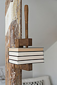 Books held in vintage vice mounted on wooden beam