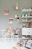 Child's table and shelves against grey wall of child's bedroom