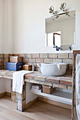 Masonry washstand and marble sink in rustic bathroom of Tuscan country house