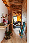 Sledge and Christmas decorations in rustic, narrow hallway