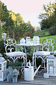 White, shabby-chic seating area on terrace with autumnal decorations