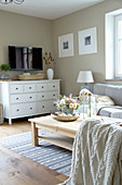 White sideboard and TV in autumnal, country-house-style living room