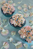 Carnations and silver balls in muffin cases decorating table