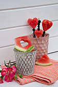 Fruit skewers of melon hearts and currants