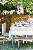 Vintage-style Easter table in set lilac and mint green in garden