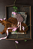 Chocolate lollies, books and asters on antique wooden tray