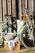 Bicycle with cushions and blankets for picnic on lake