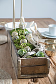 Handmade table centrepiece with snails made from pebbles and wire