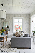Ornate wallpaper in classic living room in shades of grey