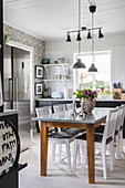 Dining table in large kitchen-dining room in Scandinavian country-house style