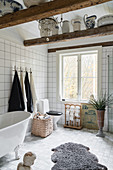 Free-standing bathtub in large bathroom decorated in vintage style