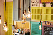 Pendant bulbs in retro style glowing against blurred wall