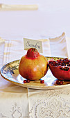 Name card held by pomegranate