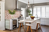 Barstools at counter in modern kitchen decorated in grey and white
